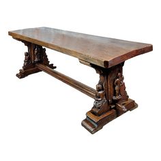 an old wooden table with carvings on the top and bottom edge, against a white background