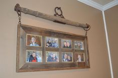 an old wooden frame hanging on the wall with family photos attached to it and chains