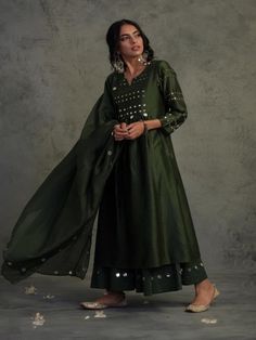 Chanderi kurta in bottle green color with mirror work on yoke and sleeves. This Front yoke gathered kurta set is paired with a chanderi dupatta with mirror work on borders and comes along with cotton flared palazos highlighted with mirrors.Perfect festive dressing for a glittery evening. Color: Bottle Green Fabric: Kurta- Chanderi Dupatta - Chanderi Palazzo - Cotton Lining - Cotton Note: Available in other colors The product will be delivered within 2-4 weeks of order placed Wash Care - Dry clea Green Kurti, Cotton Palazzo Pants, Kurta Set For Women, Sustainable Clothing Brands, Indian Outfit, Bottle Green, Mirror Work, Festival Dress, Kurta Set