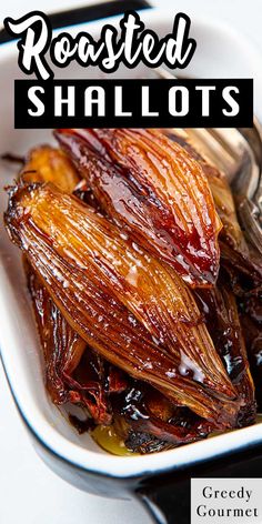 roasted shallots in a white bowl with spoons on the side and text reading roasted shallots