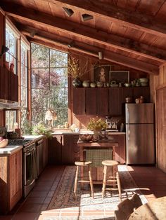 a kitchen with wooden walls and flooring in it