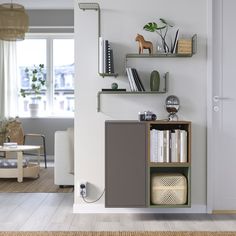 a living room with bookshelves and shelves on the wall, next to a couch