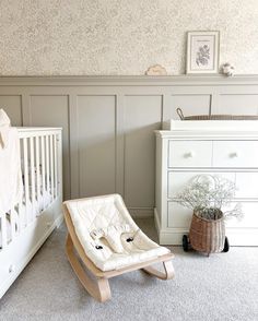 a baby's room with a crib, dresser and changing table in it