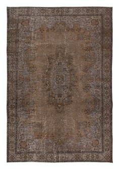 an antique rug with brown and beige colors on the bottom, it has a large medallion design