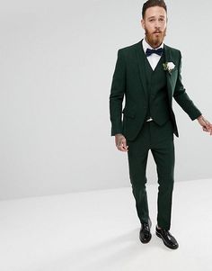 a man in a green suit and bow tie