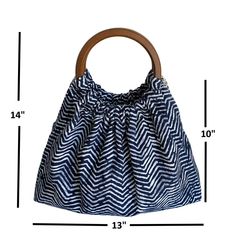 a blue and white bag with a wooden handle on the front, measurements for it