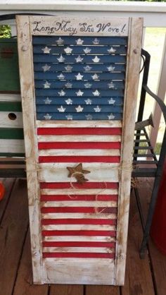 an american flag made out of old shutters