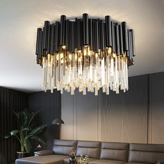 a living room filled with furniture and a large chandelier hanging from the ceiling