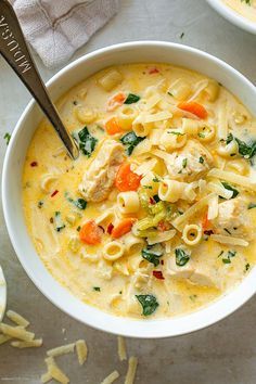 a white bowl filled with pasta and meat