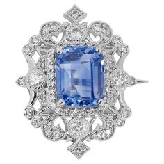 A stunning brooch with a dazzling 4.99 carat octagonal natural sapphire. It has 0.66 carats of side diamonds which add more to its elegance. The jewelry is made of 18k White Gold with a high-quality polish. It comes with a GIA certificate and a nice jewelry box. 1 sapphire main stone of 4.99 carat cut: octagonal color: blue clarity: transparent sku: B-1402 Online verification GIA 2225832253 60 diamonds side stones of total: 0.66 ct. cut: round brilliant color: F clarity: VS total carat weight: 5 Gia Certificate, Nice Jewelry, Gold Brooch, Gold Brooches, Vintage Jewels, Natural Sapphire, Exquisite Jewelry, Sapphire Diamond, Cut And Color