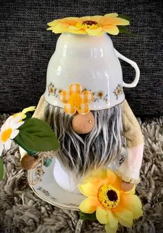 a ceramic figurine with flowers on it's head