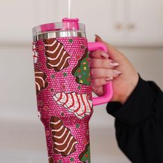 a woman is holding a pink cup in her hand and it's inside the cup