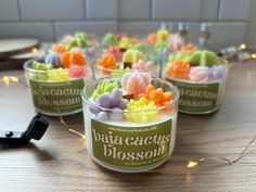 several small glass bowls filled with candies on top of a table