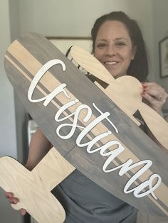 a woman holding a wooden sign that says coast guard