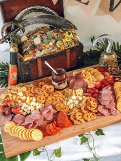 a wooden tray filled with lots of different types of snacks on top of a table