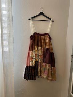 a dress hanging up against a wall