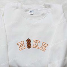 Nike x Pumpkin Horror Embroidered Sweatshirt, Nike Inspired Embroidered Shirt, Best Halloween Gift Ideas Fall College Embroidered T-shirt, White Embroidered T-shirt For Fall, Custom Embroidered Long Sleeve Top For Halloween, White Machine Embroidered Tops For Streetwear, Halloween Embroidered Long Sleeve Tops, Casual Halloween Top With Embroidered Logo, White T-shirt With Embroidered Text For Fall, Long Sleeve Tops With Machine Embroidery For Streetwear, White College Sweatshirt With Machine Embroidery