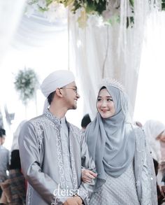 a man and woman dressed in traditional garb