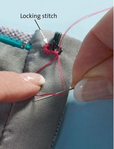 someone is stitching something on the side of a piece of fabric with a needle