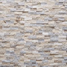 a wall made out of stone tiles with different colors and patterns on it's sides