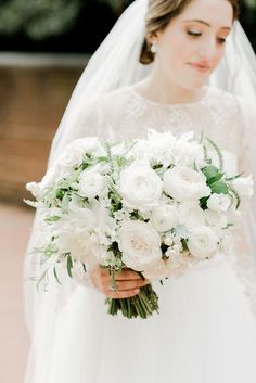 a woman in a wedding dress holding a bouquet