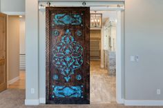 an ornate wooden door with blue paint on it in a home's entryway