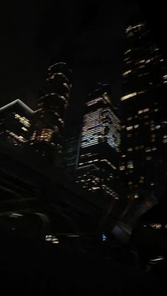 some very tall buildings at night time