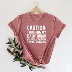 a t - shirt that says caution touching my baby bump is the best thing i've ever heard