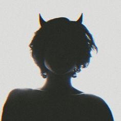 the silhouette of a woman with horns on her head