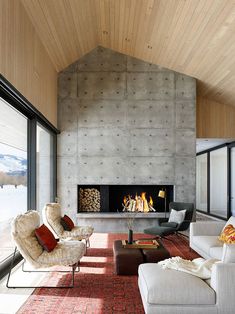 a living room with couches, chairs and a fire place in the fireplace area