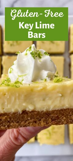 a hand holding a slice of key lime cheesecake