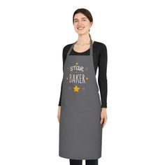 a woman wearing an apron that says star baker