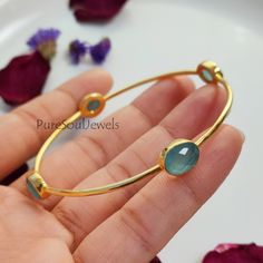 Aqua Chalcedony Bangle, 925 Silver Gold Plated Bangle, Gemstone Bangle, Friendship Bangle, Vintage Bangle, Bangle Bracelet, Designer Bangle Handmade item Gemstone: Aqua Chalcedony Materials: 925 Sterling Silver Finish: Gold Theme- Love & Friendship Style- Boho & Hippie Bangle Size-2.8X2.7 Inches Approx. Ready To Ship You can also have a look on our other amazing similar products here- >Blue Topaz Bangle- https://www.etsy.com/in-en/listing/1248466752/natural-blue-topaz-bangle-925-silver?click_key Ceremonial Gemstone Bangle Jewelry, Traditional Turquoise Bangle Bracelets, Antique Turquoise Bangle, Adjustable Artisan Blue Bangle, Turquoise Hand-strung Bangle, Gold Theme, Gold Plated Bangles, Gemstone Bangle, Vintage Bangles