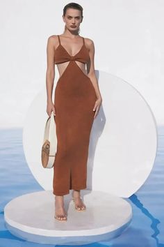 The Cult Gaia Serita is a cutout woven knit maxi dress. Thoughtful cutouts shape your figure, highlighting the small of your waist. A bra silhouette with a bare all open back. Pair with the Banu Bag and bare feet and you’re ready for a night of dancing on the beach. This dress is worth all the Instagram hype! | Designer Dress | Knit Maxi Dress | Cutout Maxi Dress | Resort Dress | Resort Outfit | Wedding Guest Dress | Sexy Maxi Dress | Designer Summer Outfit | South Beach Dress | Cruise Outift |