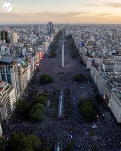 an aerial view of a large group of people in the middle of a city