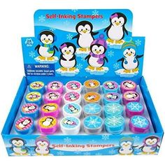 the penguin stampers are set in a display case with penguins and snowflakes on them