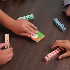 several children playing with blocks and letters on the table, while one child is placing them in