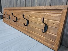 a wooden coat rack with hooks on it