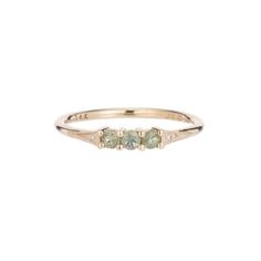 three stone ring in yellow gold with diamonds on the sides and an oval shaped band