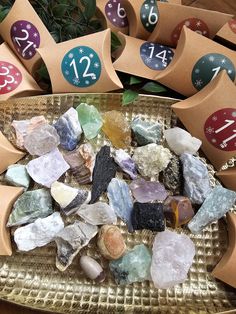 several different types of rocks and numbers on a tray