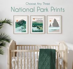 a crib with three posters on the wall above it that says choose any three national park prints