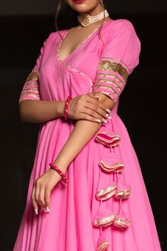 Romance with Indian dress in this vibrant pink color pure cotton angrakha anarkali suit set. With a regal intricate pattern of designing and gotta work on borders of suit and dupatta, you can never go wrong with this breathtaking ensemble. PRODUCT DESCRIPTION: Kurta & Pant: Coton Dupatta: Kota Doria Color: Pink No. Of Components : Set of 3 Embroidery Details: Lace Work Wash Care : Dry Clean Customization : Only Size and Length Of Product SKU#: 11403102PK Disclaimer: All our pieces are handcrafte Traditional Pink Anarkali Set In Cotton Silk, Pink Anarkali Cotton Silk Salwar Kameez, Pink Cotton Silk Dupatta With Gota Work, Traditional Anarkali Set In Pink With Gota Work, Designer Pink Anarkali Set With Gota Work, Designer Wear Pink Anarkali Set With Gota Work, Pink Anarkali Kurta With Mirror Work, Pink Bollywood Cotton Silk Dress, Pink Bollywood Style Cotton Silk Dress