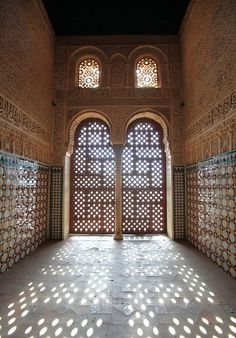 sunlight streams through the windows in an ornate building