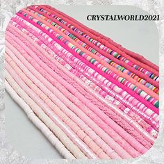 a pile of pink and white paper stacked on top of each other with the words crystalworld