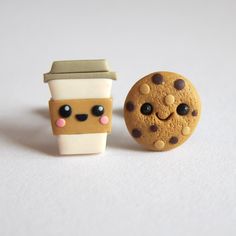 there is a cookie and a cup of coffee next to each other on the table