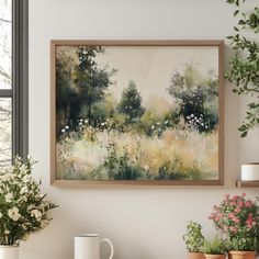 a painting hanging on the wall next to some potted plants and two mugs