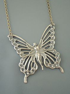 "Vintage Jewelry - Vintage Necklace - Butterfly Fairy Necklace - Butterfly Necklace - Brass Necklace - Boho Necklace - Chloe's Vintage handmade jewelry This is such a beautiful vintage brass necklace! A large Art Nouveau butterfly fairy. It hangs from a pretty vintage brass ladder chain necklace. So very bold and feminine. Chloe says, \"Wear it and feel fabulous!\" The pendant is 2 1/8\" wide and 2 1/4\" tall. You can choose the necklace length you would like at checkout. Thanks for visiting Chl Handmade Silver Fairy Necklace, Handmade Whimsical Butterfly Necklace, Whimsical Handmade Butterfly Necklace, Handmade Butterfly Necklaces In Fairycore Style, Handmade Butterfly Fairycore Necklaces, Handmade Fairycore Butterfly Necklaces, Handmade Fairycore Butterfly Necklace, Handmade Gold Fairy Necklace, Handmade Fairy Gold Necklace