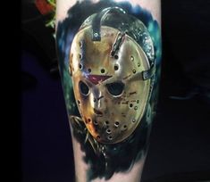 a tattoo with a mask painted on it