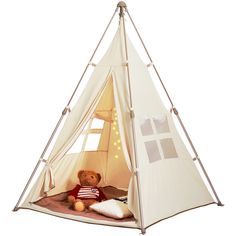 a teddy bear is sitting in a teepee tent