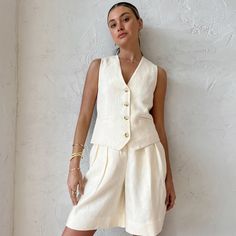 Elevate your summer style with our Beige Sleeveless Vest Two-Piece Suit for Women. This breathable and loose-fitting ensemble is designed to keep you comfortable and chic during the warmer months. The sleeveless vest adds a touch of sophistication, while the cotton linen fabric ensures breathability and comfort. Whether you're dressing up for a special occasion or opting for a relaxed summer look, this two-piece suit has you covered. The versatile beige color complements various outfits and occa Two Piece Shorts Set, Linen Design, Linen Vest, Plain Style, Cotton Linen Fabric, Sleeveless Vest, Linen Shorts, Casual Look, Look Chic